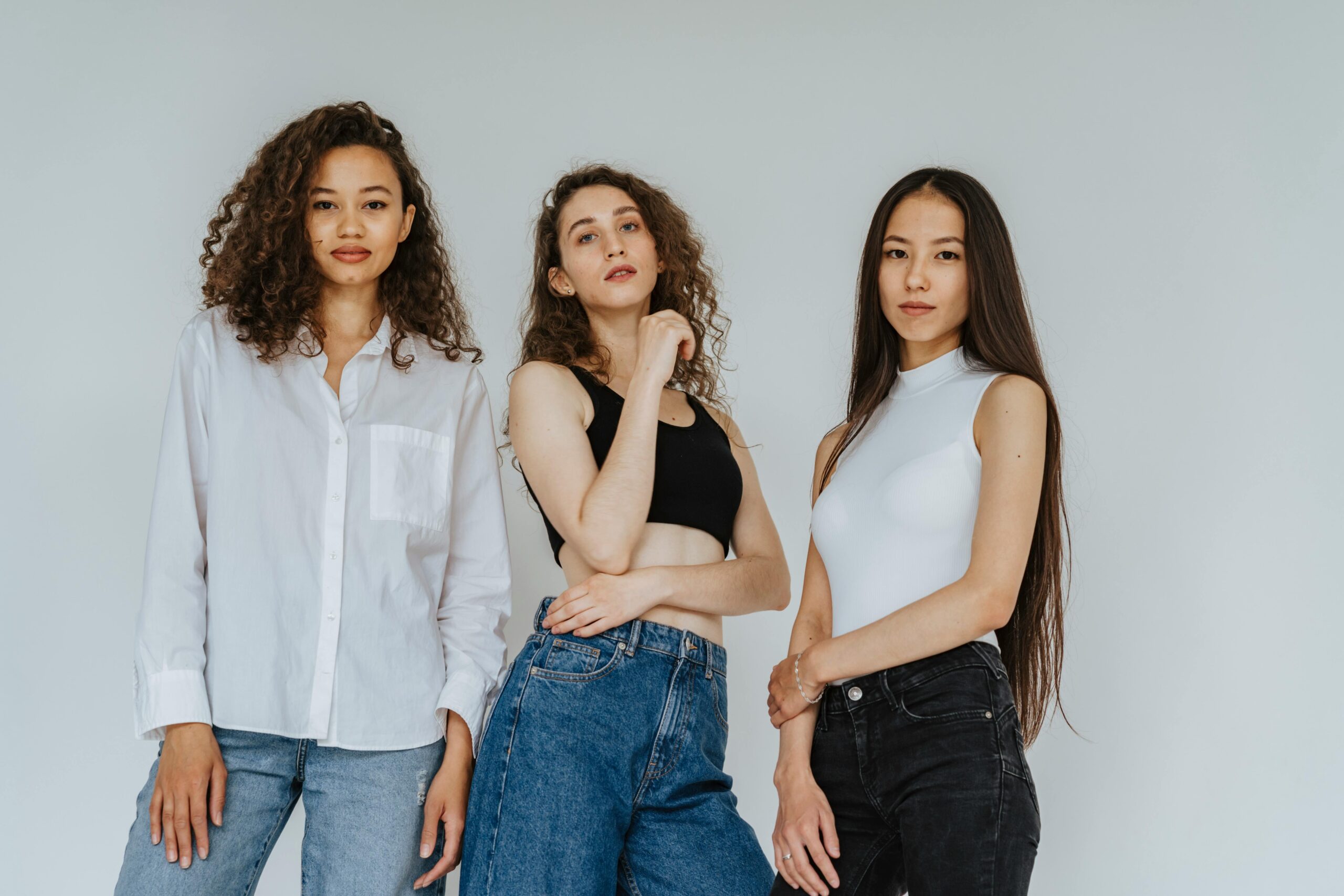 pexels-photo-4723162-4723162 Trio of diverse women posing in casual denim and stylish tops for a contemporary photoshoot.
